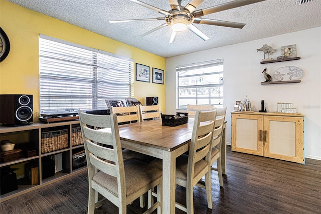 dining space featuring ceiling fan, dark hardwood / wood-style floors, and a textured ceiling