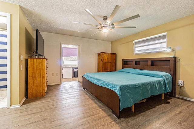 bedroom with ceiling fan, a textured ceiling, and light wood-type flooring