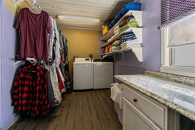 clothes washing area with dark hardwood / wood-style floors and separate washer and dryer