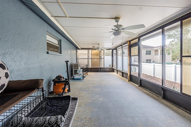 sunroom featuring ceiling fan