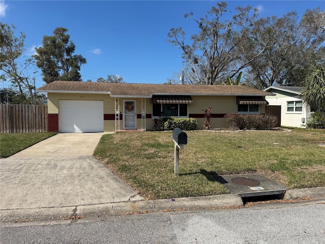 ranch-style house with a garage and a front yard