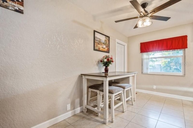 tiled dining room with ceiling fan