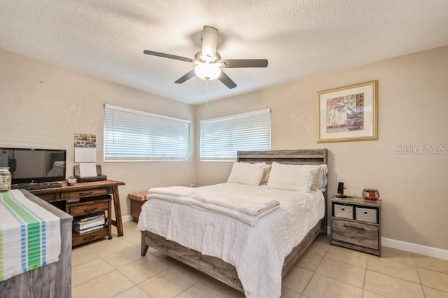 bedroom with light tile patterned flooring, ceiling fan, and a textured ceiling