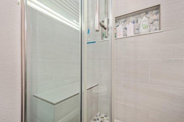 bathroom with a shower with shower door