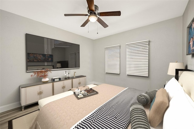 bedroom with wood-type flooring and ceiling fan