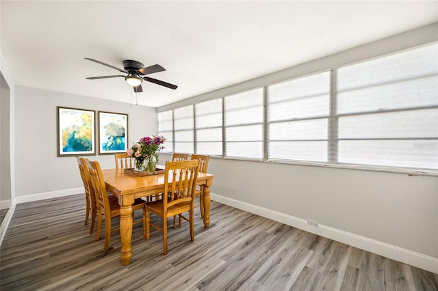 dining space featuring ceiling fan and hardwood / wood-style floors