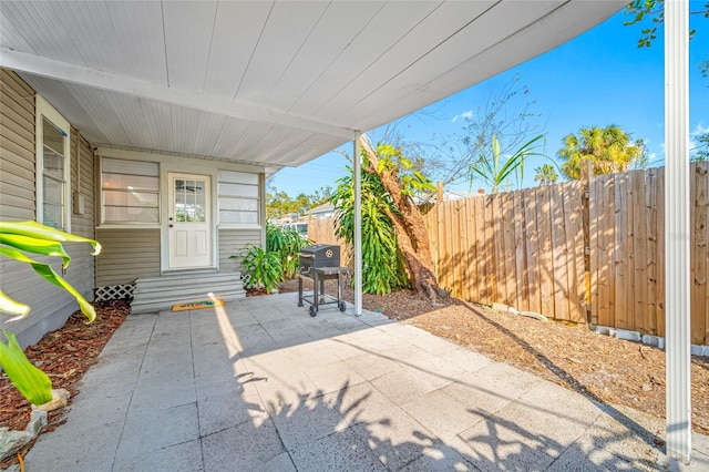 view of patio featuring entry steps, fence, and area for grilling