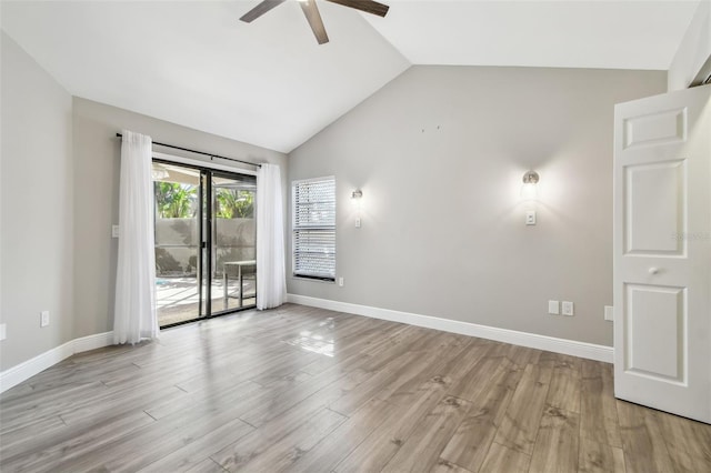 empty room with ceiling fan, lofted ceiling, and light hardwood / wood-style flooring