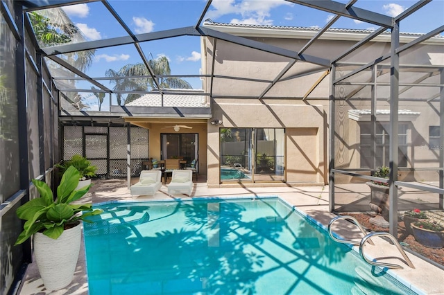 view of swimming pool with a lanai, a patio area, and ceiling fan