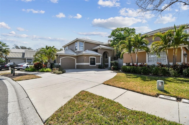 view of front of property with a garage and a front lawn