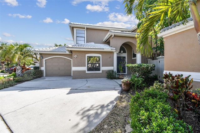 mediterranean / spanish-style home featuring a garage