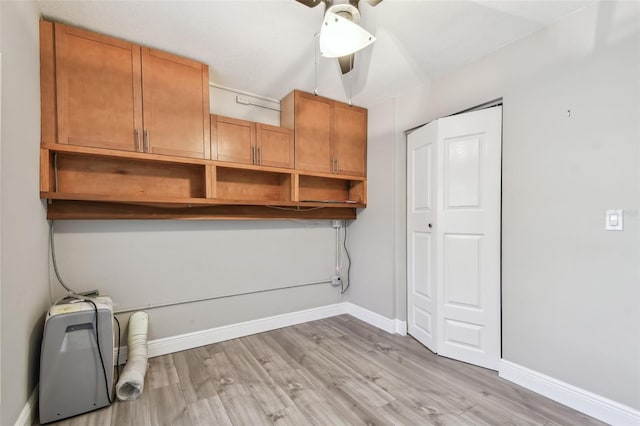 washroom featuring cabinets and light hardwood / wood-style flooring