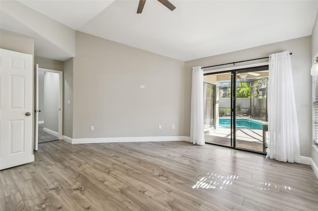 unfurnished room with ceiling fan, lofted ceiling, and light hardwood / wood-style floors