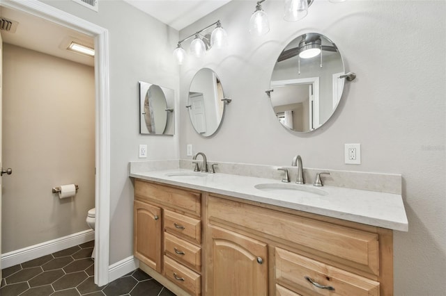 bathroom with tile patterned floors, vanity, and toilet