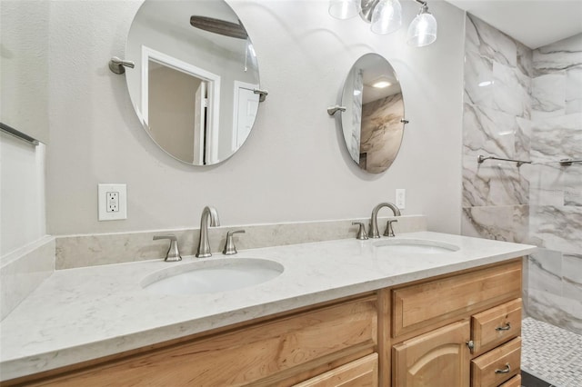 bathroom with vanity and a tile shower