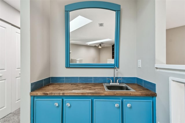 bathroom with ceiling fan and vanity