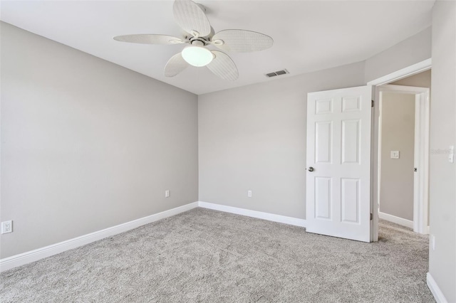 empty room with light colored carpet and ceiling fan