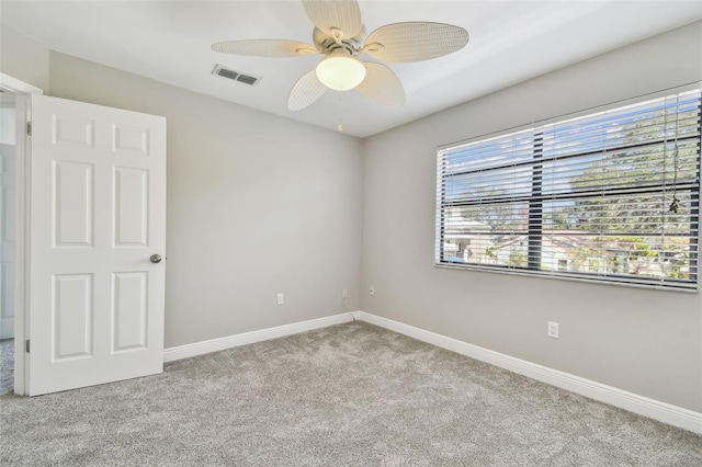 carpeted spare room with ceiling fan