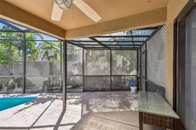 unfurnished sunroom with ceiling fan