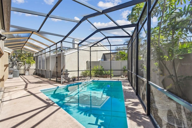 view of pool featuring a lanai, a patio area, and central air condition unit