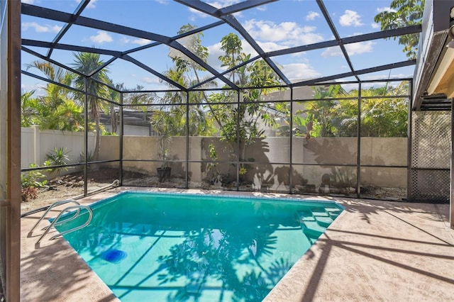 view of swimming pool with a lanai and a patio