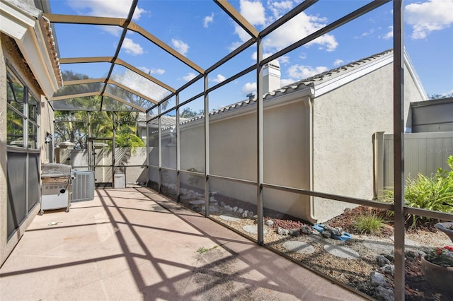 view of patio / terrace featuring a lanai