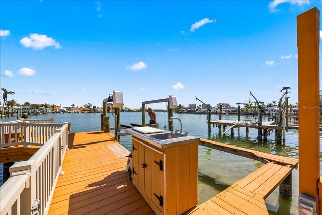 dock area with a water view and sink