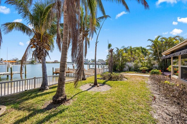 view of yard with a boat dock and a water view