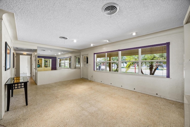 unfurnished room featuring a textured ceiling