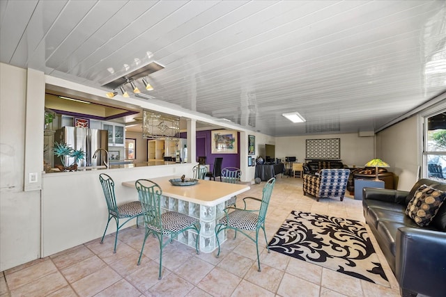 dining space with sink and light tile patterned floors