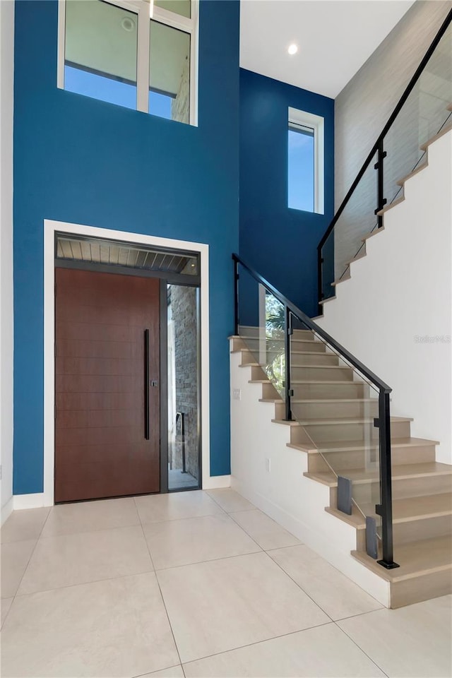 tiled entryway featuring a high ceiling