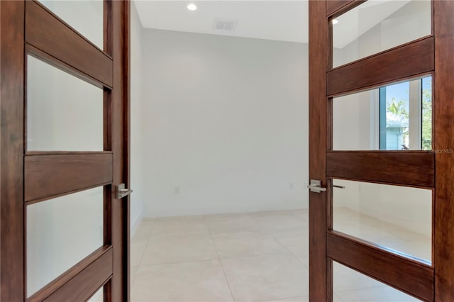 hallway featuring light tile patterned floors