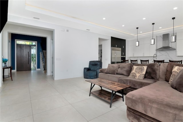 tiled living room featuring a tray ceiling