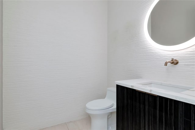 bathroom featuring tile walls, vanity, tile patterned flooring, and toilet