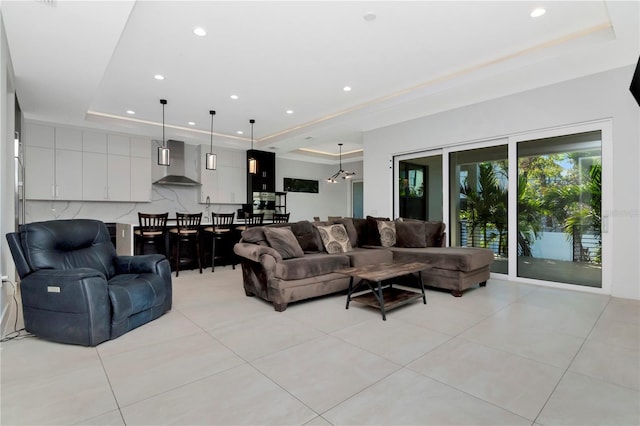 tiled living room featuring a tray ceiling