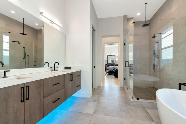 bathroom with plus walk in shower, tile patterned flooring, and vanity