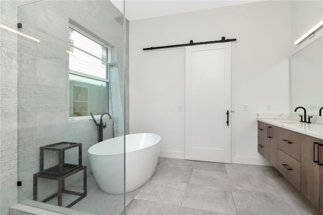 bathroom featuring tile patterned flooring, vanity, and a tub to relax in