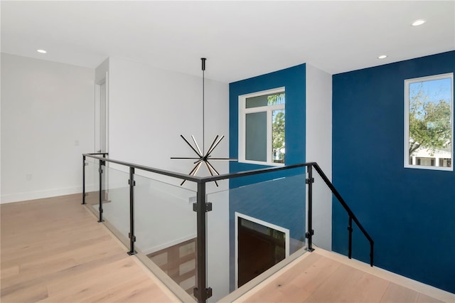 corridor with hardwood / wood-style flooring