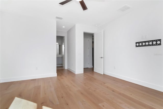 unfurnished room with ceiling fan and light wood-type flooring