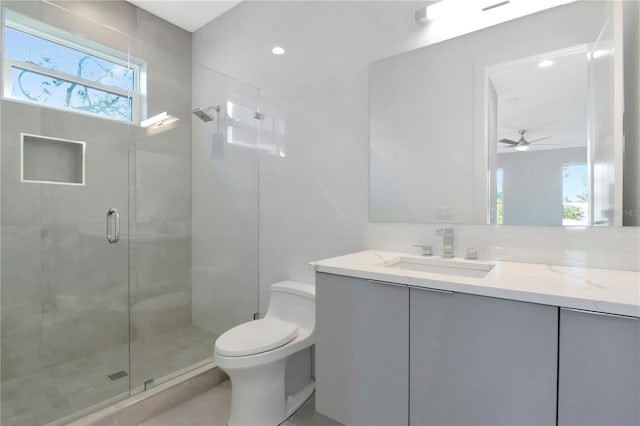 bathroom with backsplash, vanity, ceiling fan, walk in shower, and toilet