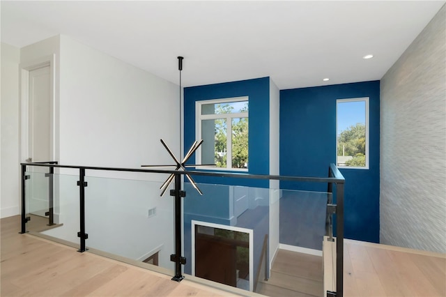 stairway with hardwood / wood-style floors