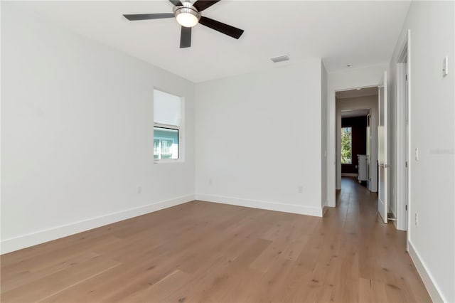 unfurnished room featuring ceiling fan, light hardwood / wood-style floors, and a wealth of natural light