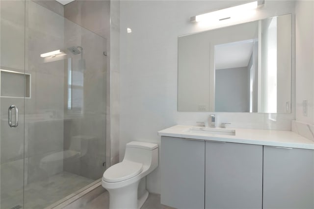 bathroom with vanity, an enclosed shower, and toilet