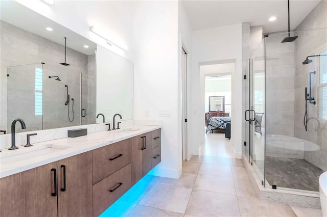 bathroom featuring tile patterned floors, vanity, and a shower with door