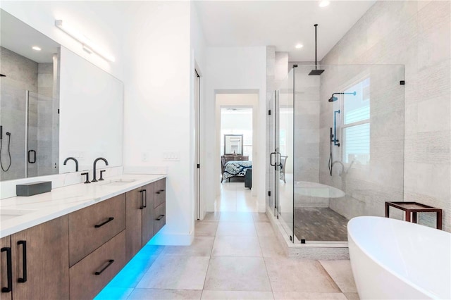 bathroom with tile patterned floors, plus walk in shower, tile walls, and vanity