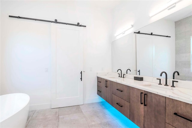 bathroom featuring tile patterned floors, a bathtub, and vanity