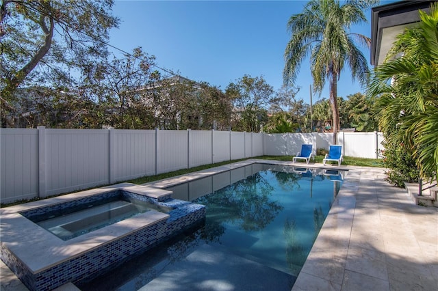 view of pool with an in ground hot tub and a patio area