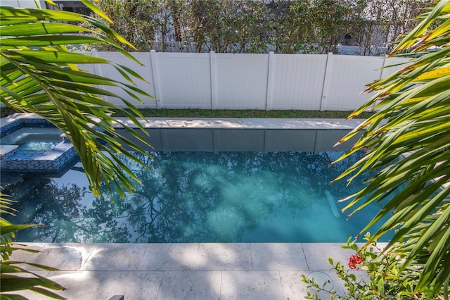 view of pool with an in ground hot tub