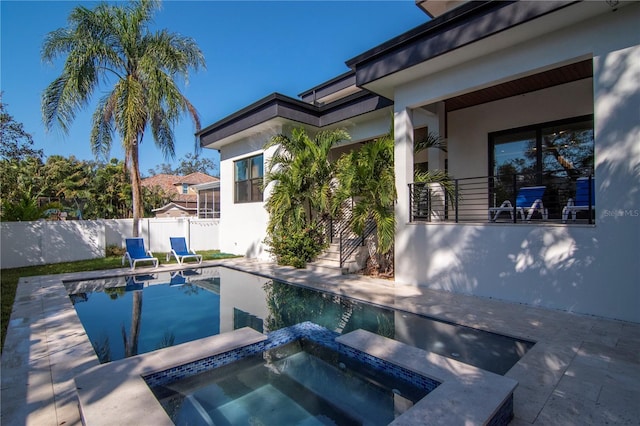 view of pool with an in ground hot tub and a patio area