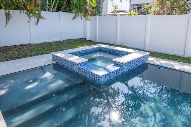 view of swimming pool with an in ground hot tub